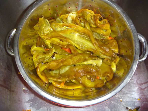 Peeled chiles in colander
